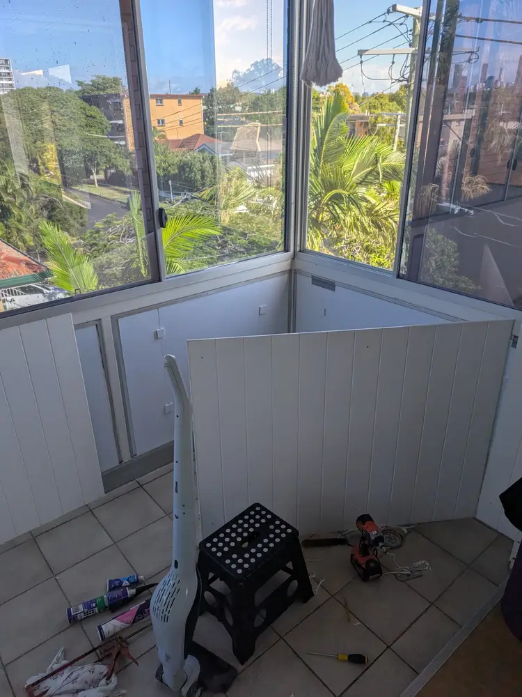 Sunroom mid-job, with new white VJ wall panels being fitted over the old wall lining