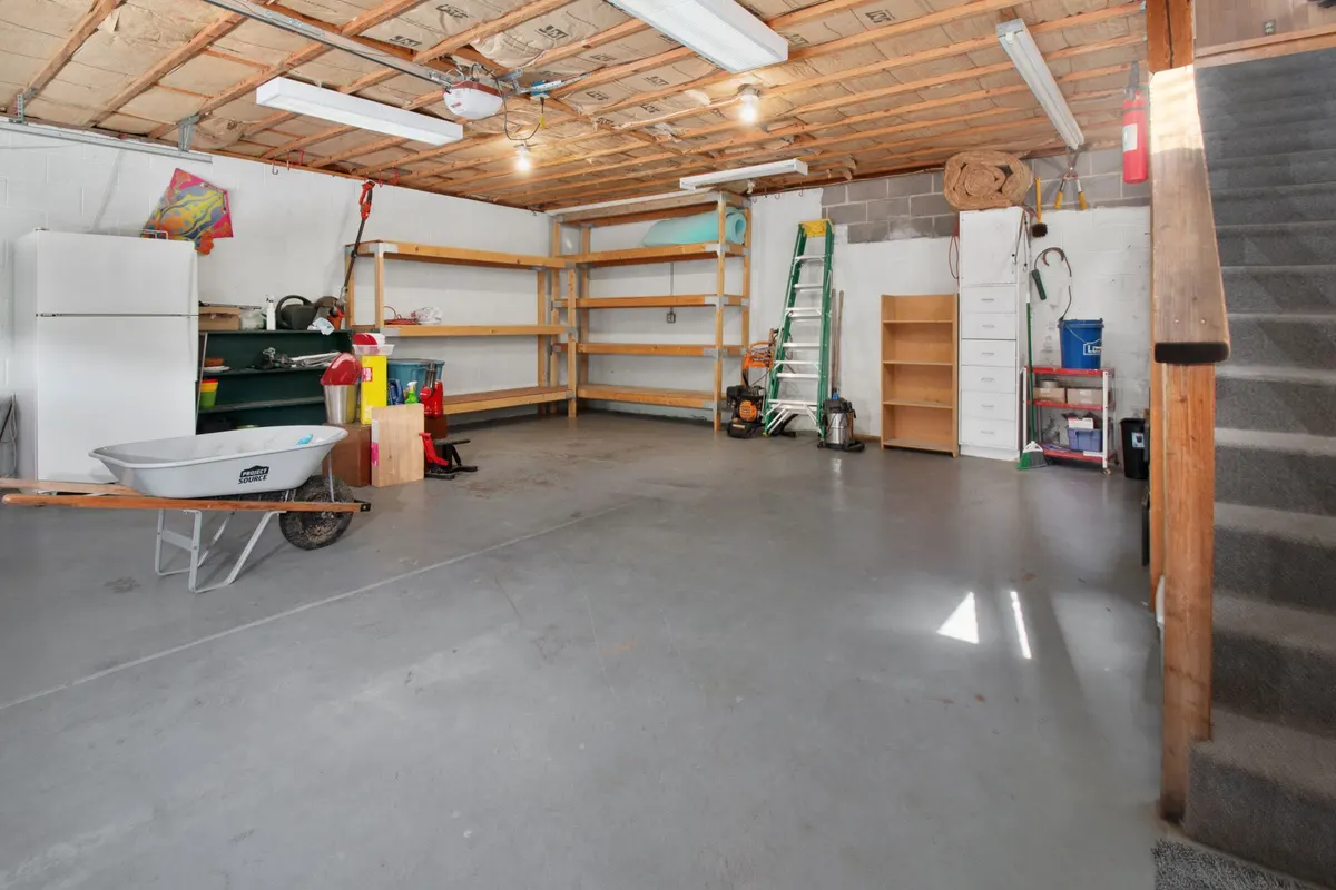 Tidy garage with timber shelving, ladder and storage, cleared and organised