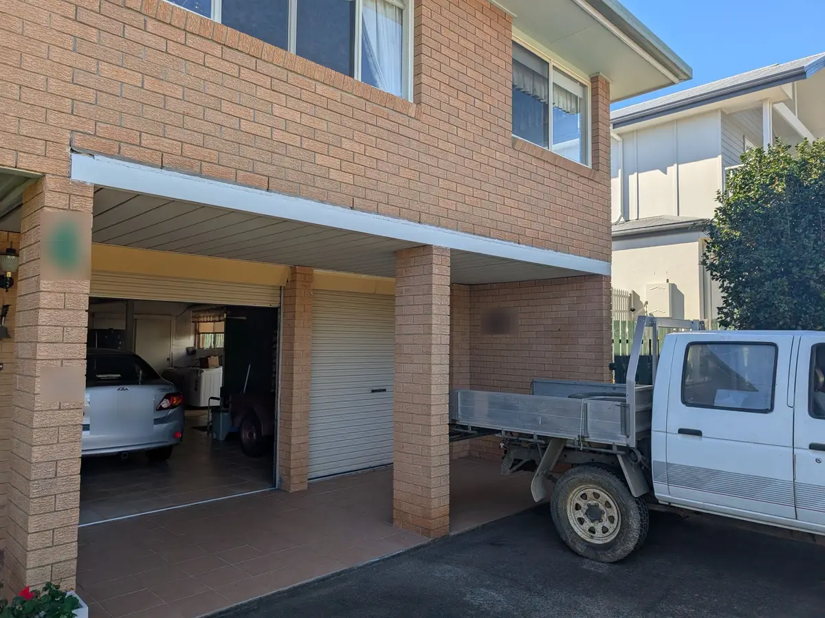After: the same carport beam, rust treated and repainted clean white